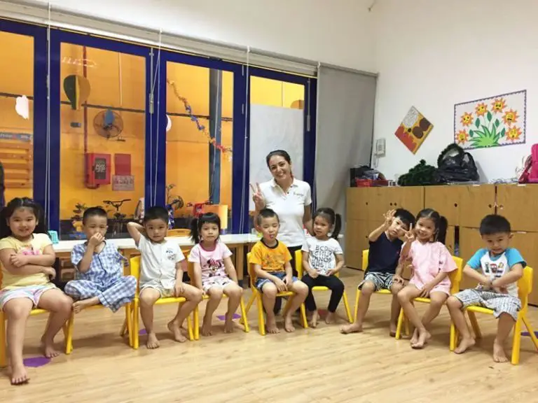 Happy ESL Teacher in the classroom with Chinese little kids